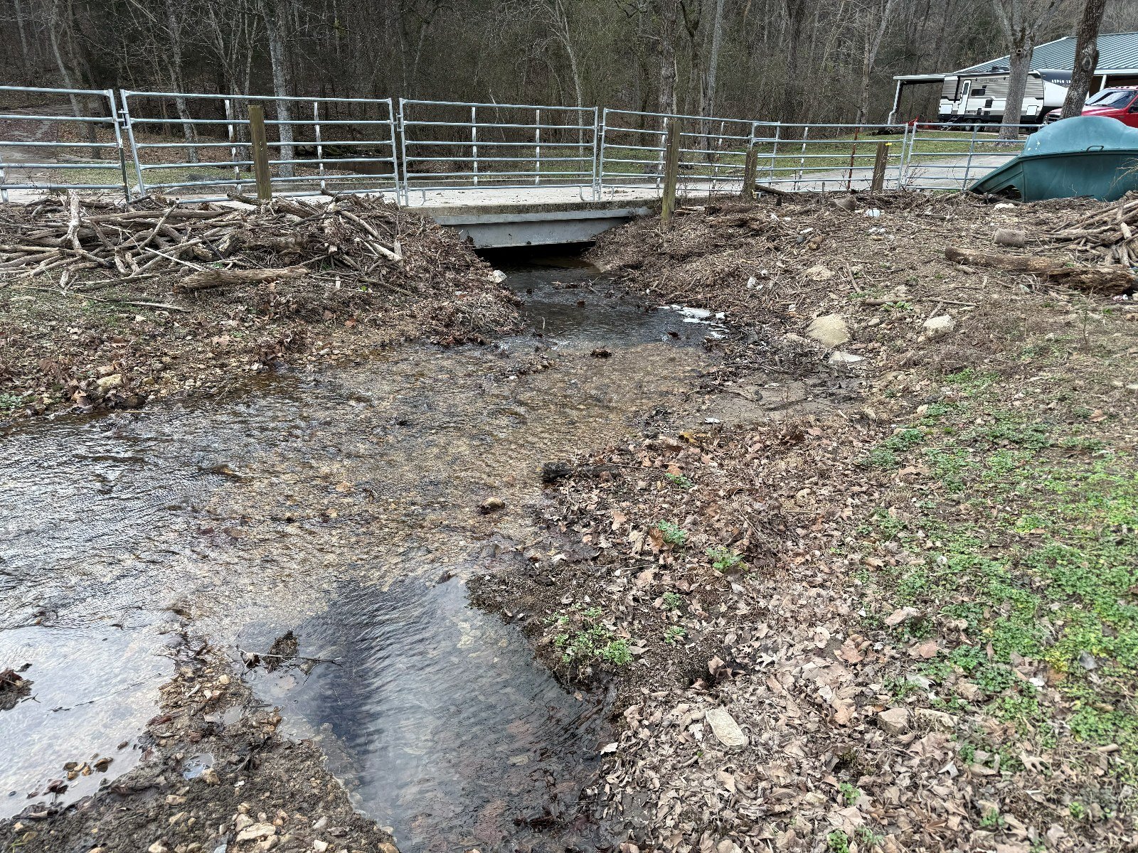 Before: culvert crossing choked with debris and eroded banks